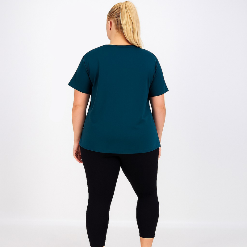 Person wearing a teal t-shirt and black leggings on a white background