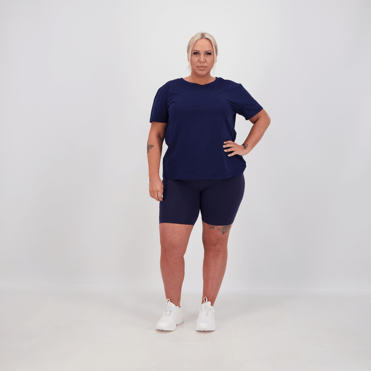 woman wearing bike shorts and shirt in colour navy