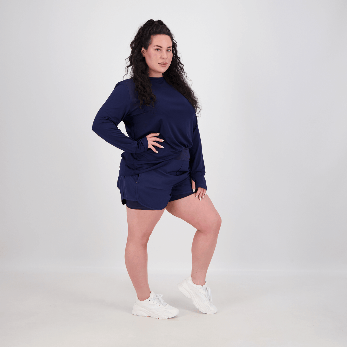 woman wearing long sleeve and bike shorts for workout
