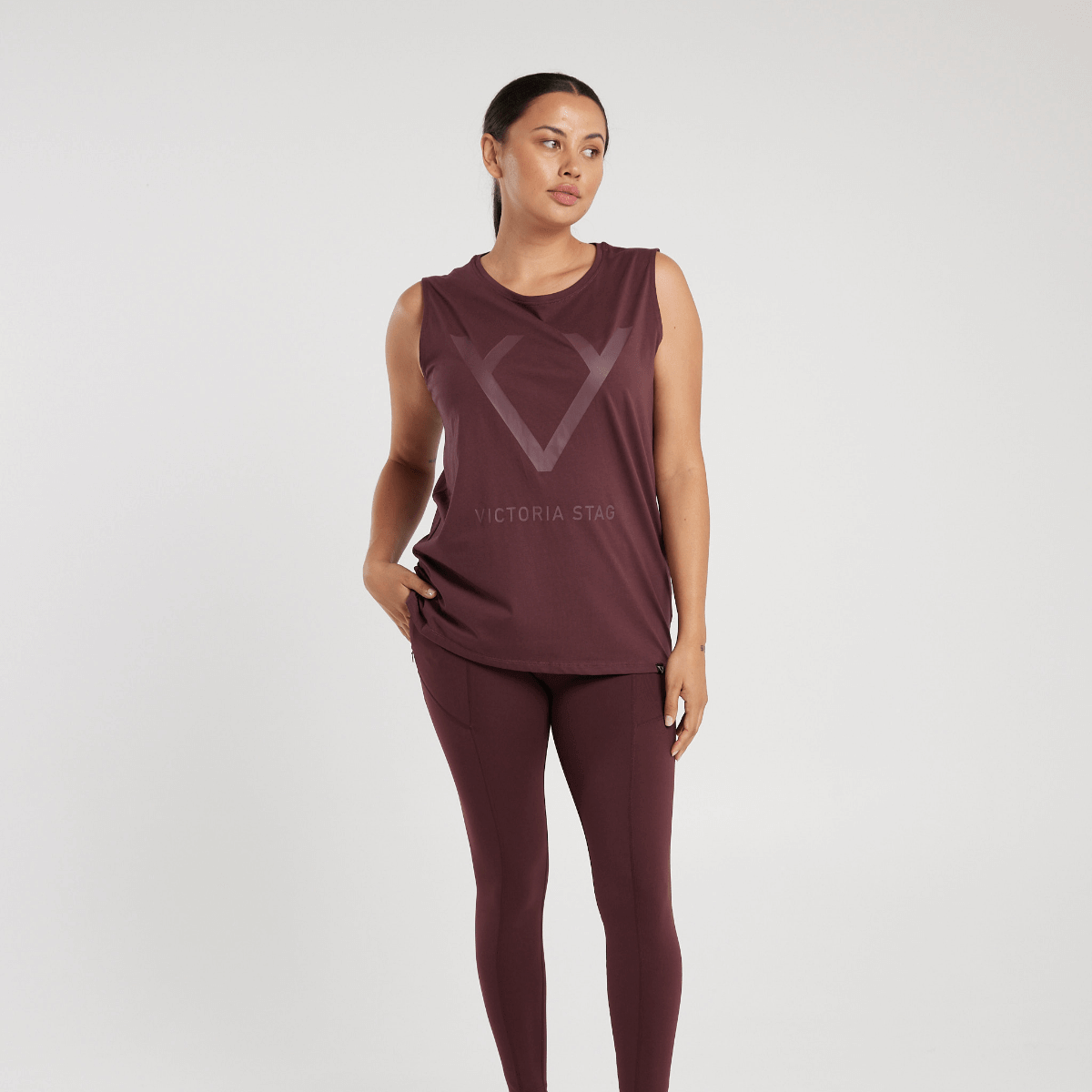 Woman wearing Victoria Stag's Core Muscle Tank in Ox Blood