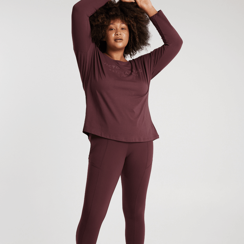 Woman wearing Victoria Stag's Elite Long Sleeve Tee in Ox Blood