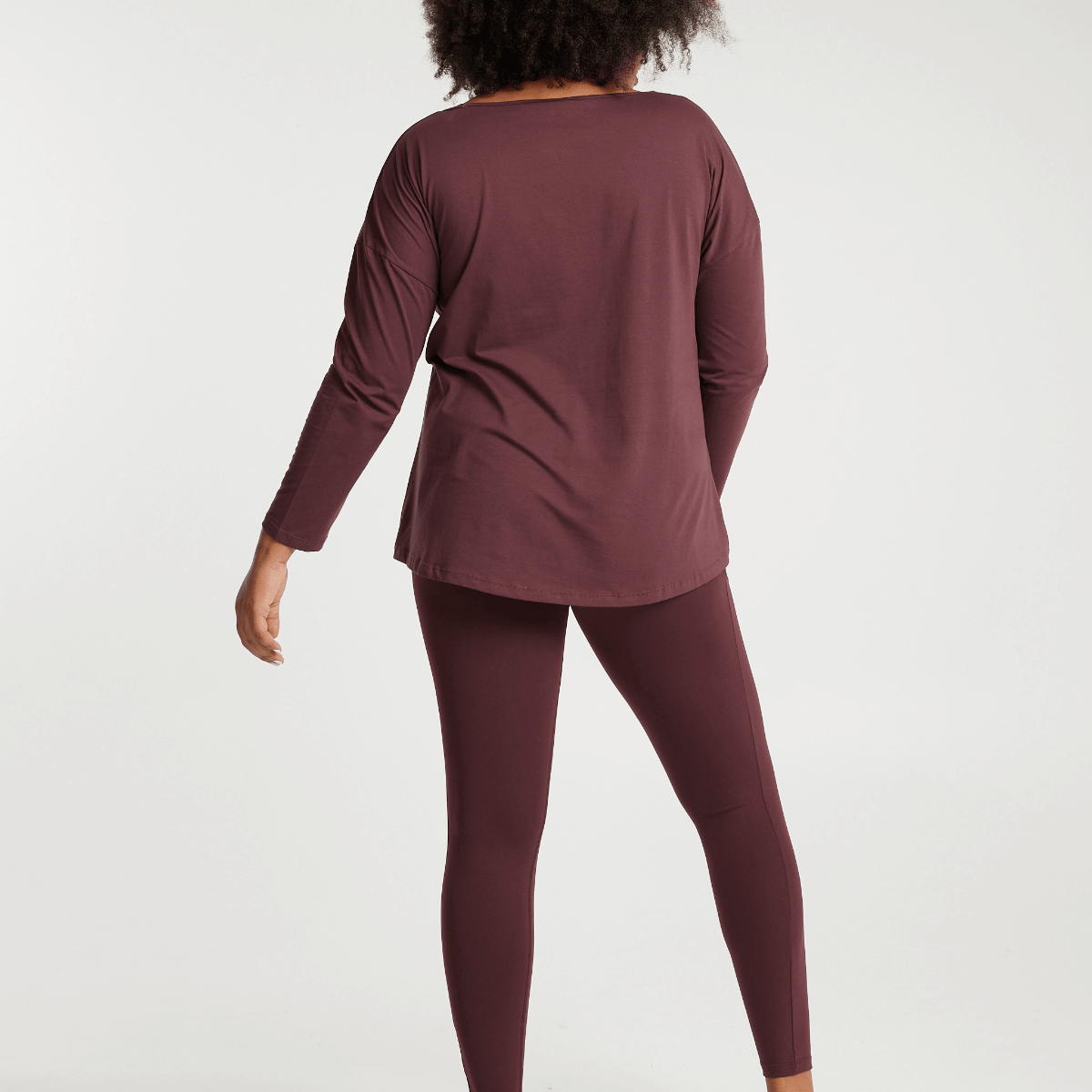 Woman wearing Victoria Stag's Elite Long Sleeve Tee in Ox Blood back