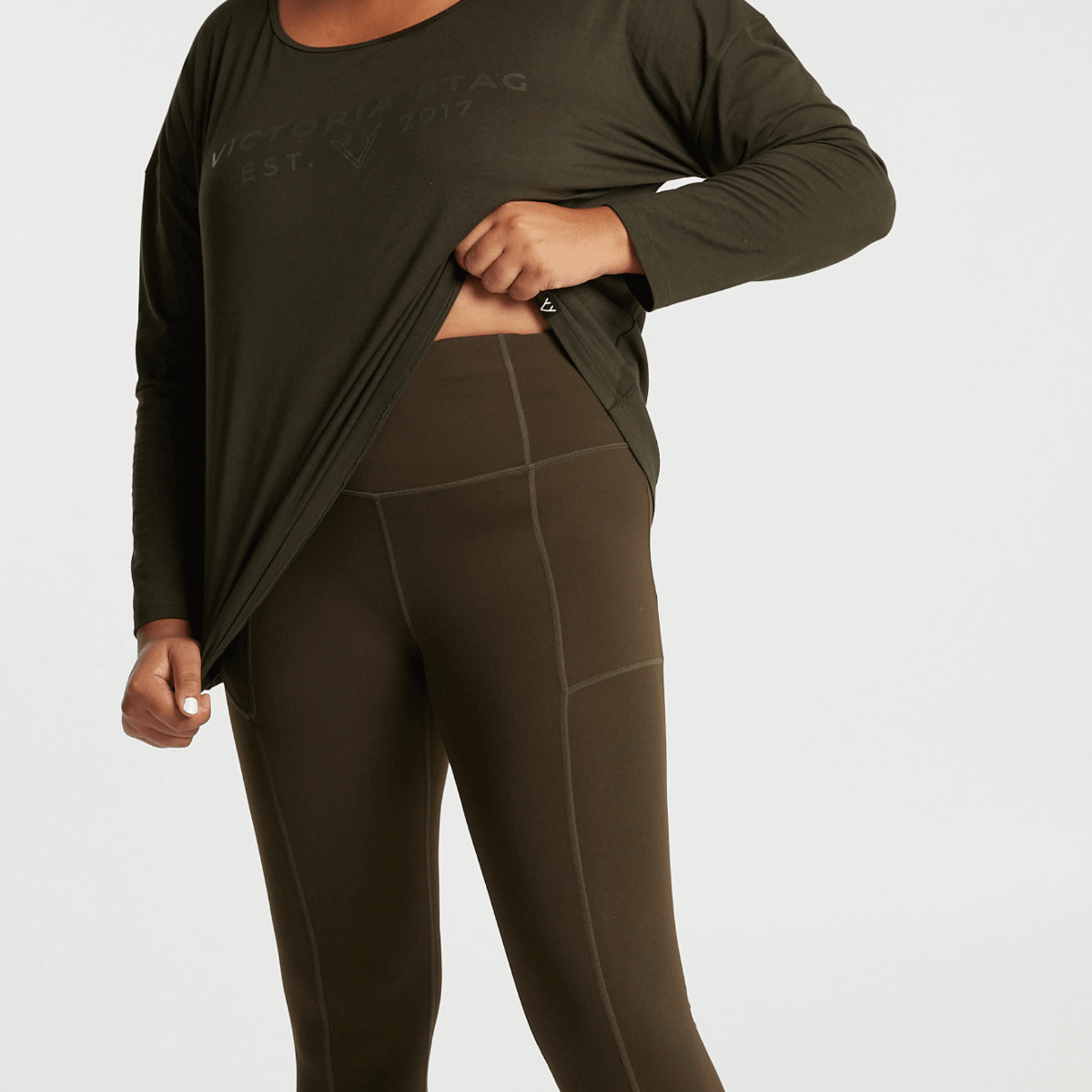 Woman wearing Victoria Stag's core 3/4 length tights in khaki 